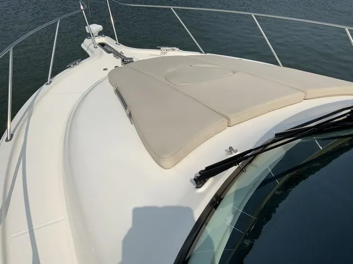 Intuition Yacht Photos Pics Tiara Yachts 36, 2013 model, bow view with cushioned sunpad on calm water.