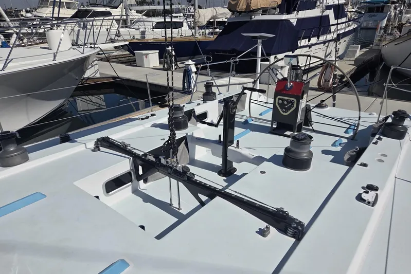 Grand Illusion Yacht Photos Pics 1986 Santa Cruz 70 sailboat deck with winches and rigging in a marina.