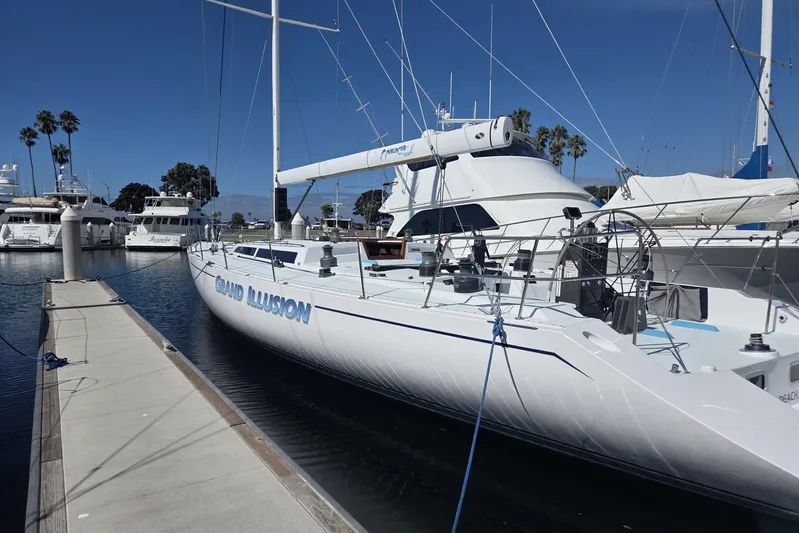 Grand Illusion Yacht Photos Pics 1986 Santa Cruz 70 yacht "Grand Illusion" docked at marina, clear sky, palm trees in background.