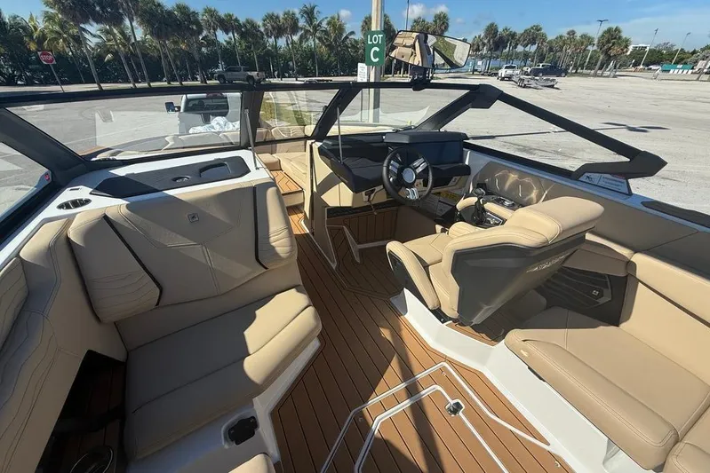  Yacht Photos Pics 2026 Nautique Super Air Nautique G25 Coastal Edition interior with tan seating and modern dashboard.