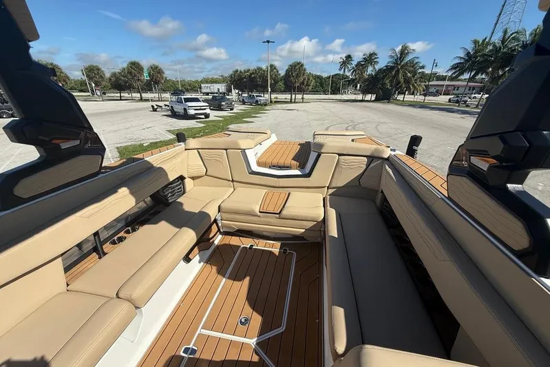  Yacht Photos Pics 2026 Nautique Super Air Nautique G25 Coastal Edition interior with tan seating and teak flooring.