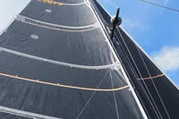 Sail of 2018 Outremer 4X catamaran against a clear blue sky.