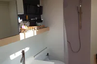Modern bathroom in 2018 Outremer 4X yacht with skylight, sink, toilet, and shower.