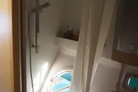 Bathroom interior of 2018 Outremer 4X yacht with shower and porthole.