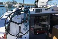 2018 Outremer 4X sailboat cockpit with steering wheel and navigation equipment in marina.