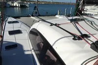 2018 Outremer 4X catamaran docked at marina, showcasing sleek design and rigging.