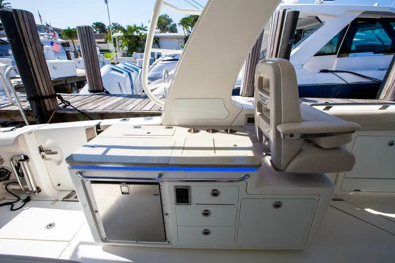  Yacht Photos Pics 2019 Boston Whaler 380 Realm interior with seating and storage compartments.