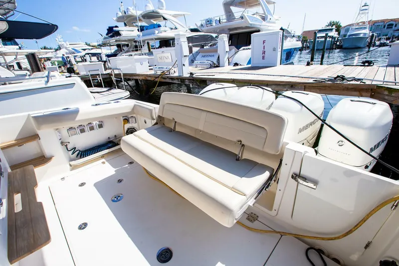  Yacht Photos Pics 2019 Boston Whaler 380 Realm boat with seating and docked yachts in background.