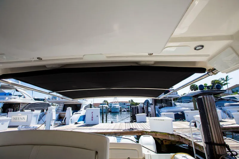  Yacht Photos Pics 2019 Boston Whaler 380 Realm docked at marina, view from under canopy.