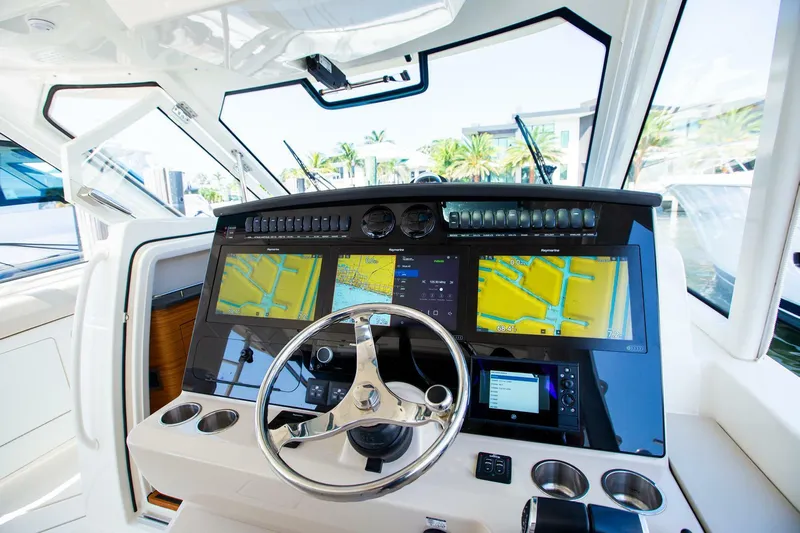  Yacht Photos Pics Control panel of a 2019 Boston Whaler 380 Realm boat with navigation screens.