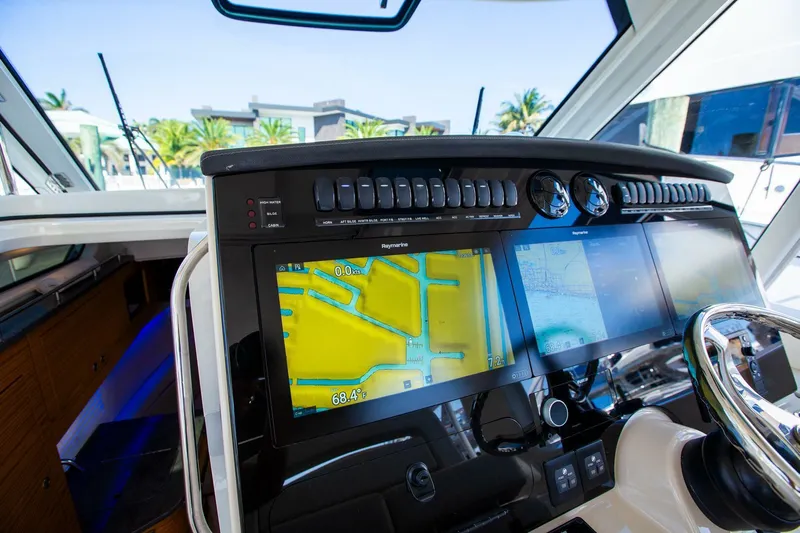  Yacht Photos Pics Control panel of 2019 Boston Whaler 380 Realm with navigation screens and steering wheel.
