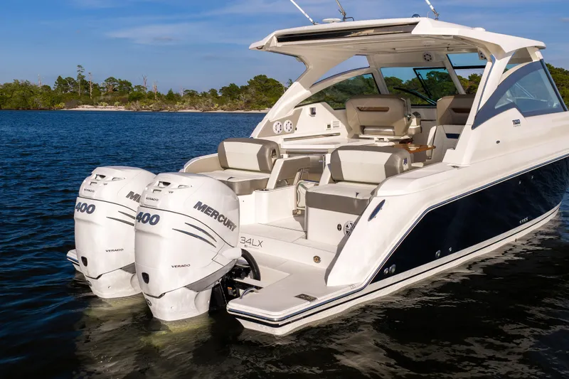 34 Tiara 2022 Yacht Photos Pics 2022 Tiara 34 LX boat with dual Mercury 400 engines on a calm lake.