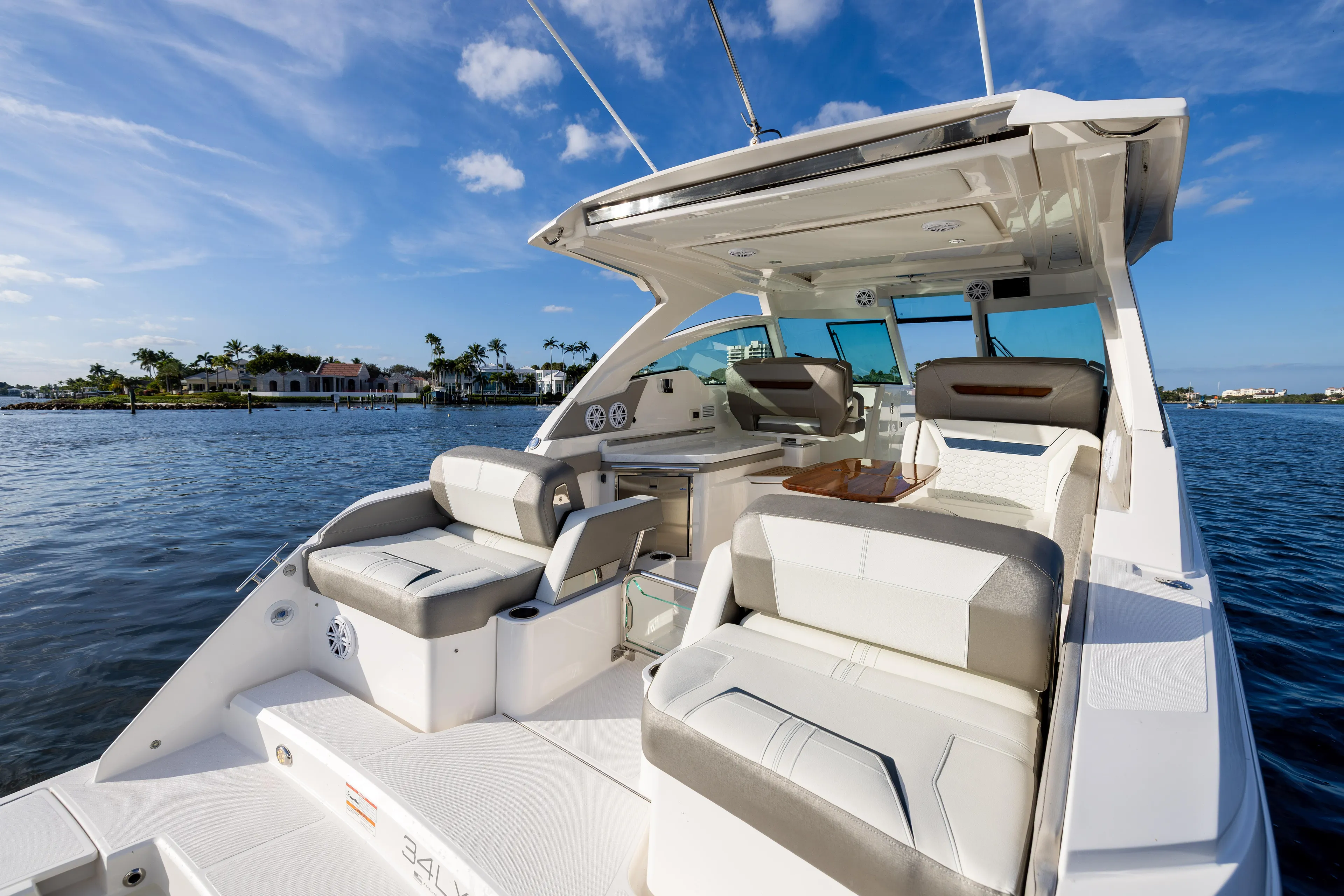 34 Tiara 2022 Yacht Photos Pics Luxurious 2022 Tiara 34 LX boat interior with plush seating on a sunny day.