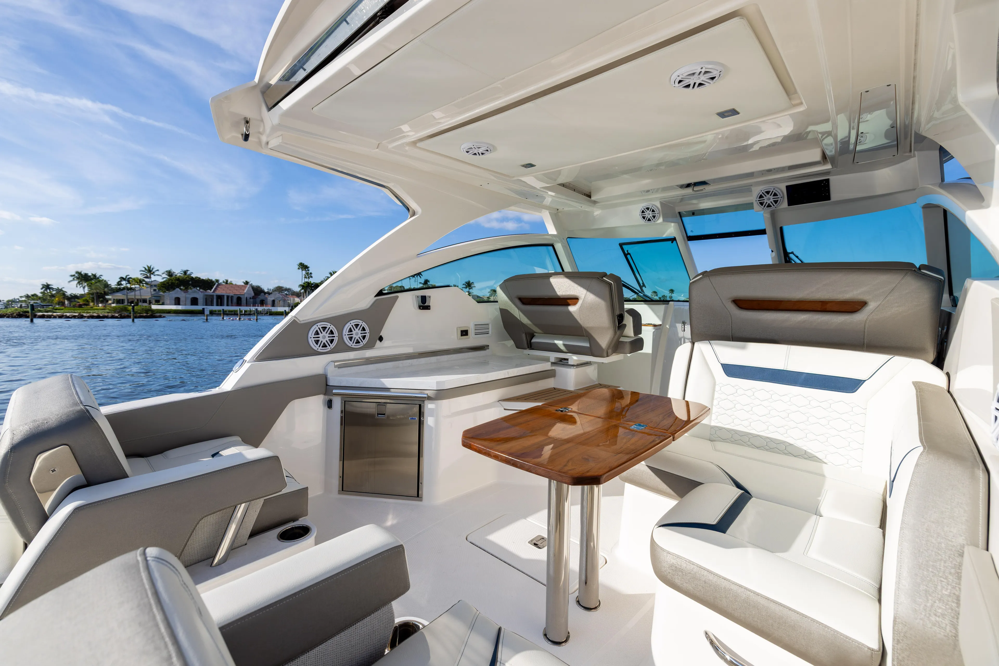 34 Tiara 2022 Yacht Photos Pics Luxurious 2022 Tiara 34 LX boat interior with elegant seating and wooden table.