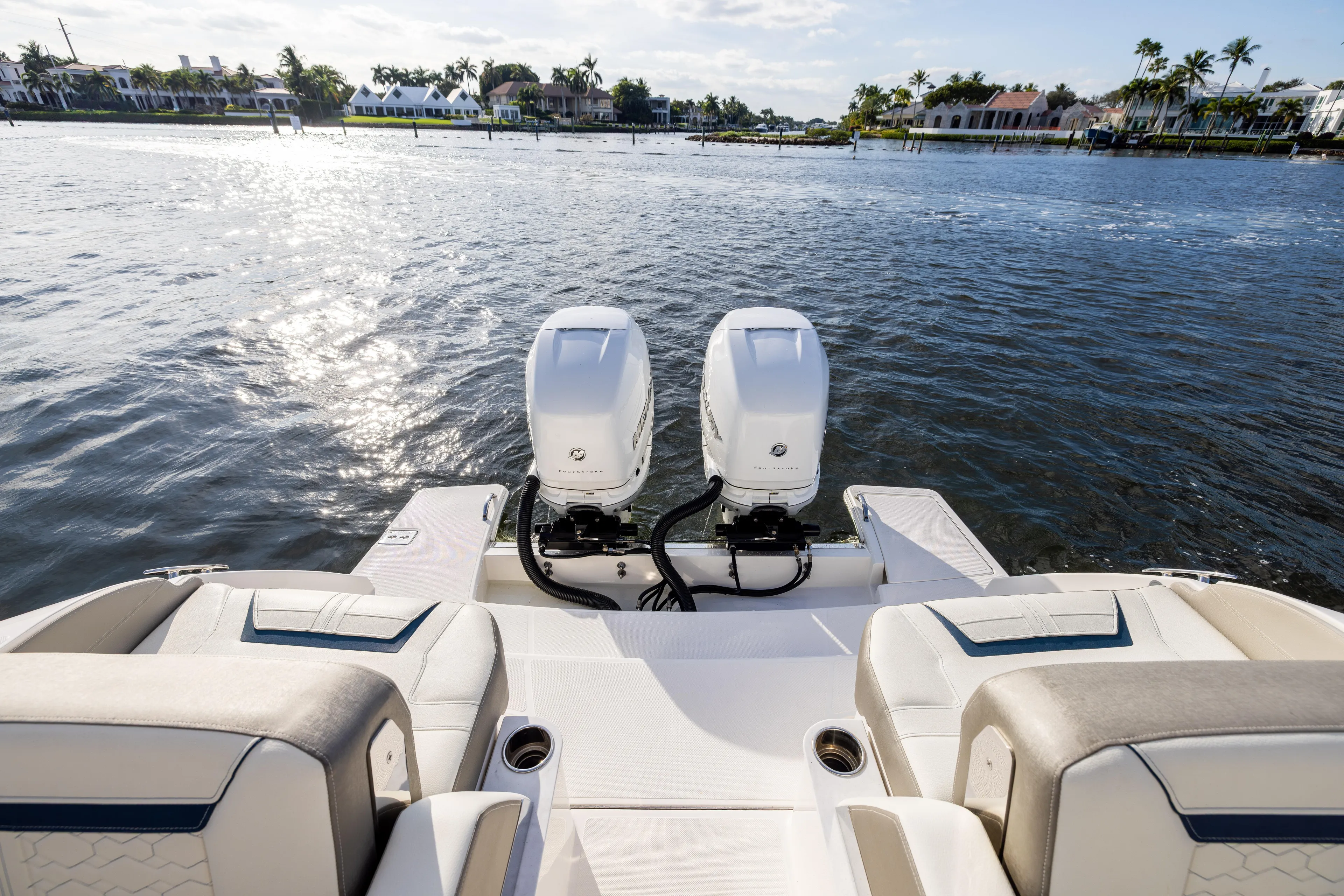 34 Tiara 2022 Yacht Photos Pics 2022 Tiara 34 LX boat with dual engines on a sunny waterfront.