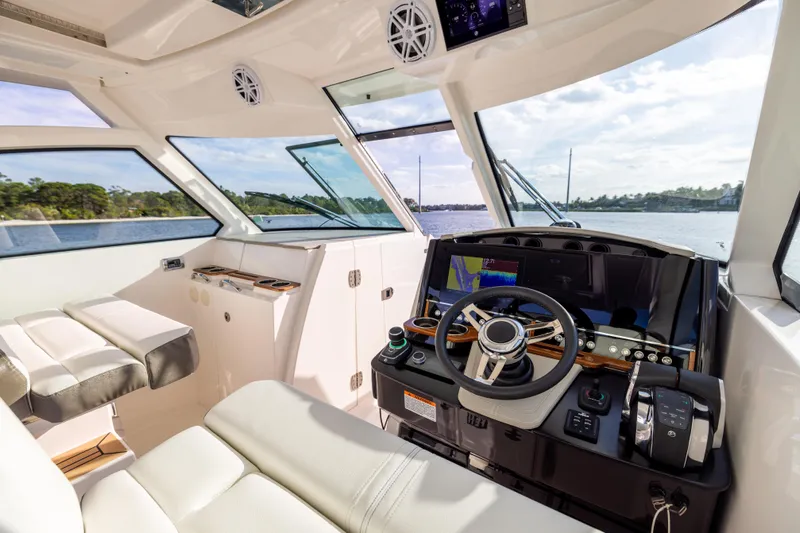 34 Tiara 2022 Yacht Photos Pics Interior of 2022 Tiara 34 LX boat with modern helm and scenic water view.