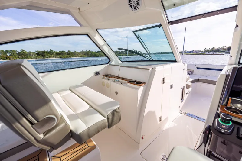 34 Tiara 2022 Yacht Photos Pics Interior of 2022 Tiara 34 LX boat with modern seating and panoramic windows.