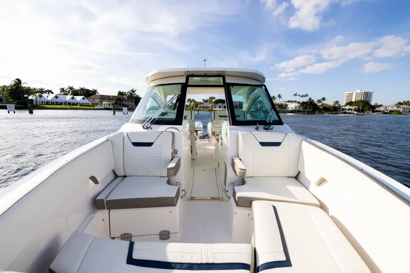 34 Tiara 2022 Yacht Photos Pics 2022 Tiara 34 LX boat interior with luxurious seating on a sunny day.