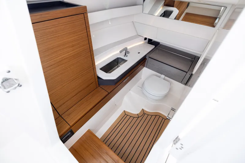 34 Tiara 2022 Yacht Photos Pics 2022 Tiara 34 LX yacht bathroom with modern wood accents and sleek fixtures.