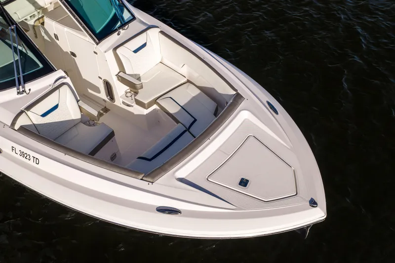 34 Tiara 2022 Yacht Photos Pics 2022 Tiara 34 LX boat with white seating, docked on dark water.