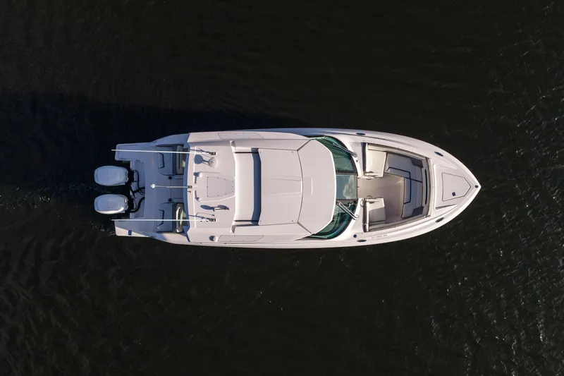 34 Tiara 2022 Yacht Photos Pics Aerial view of 2022 Tiara 34 LX boat on dark water.