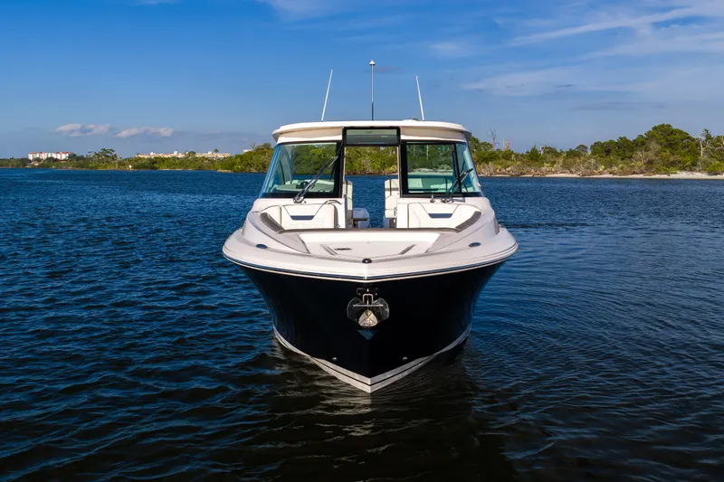 34 Tiara 2022 Yacht Photos Pics 2022 Tiara 34 LX boat on calm water with scenic background.