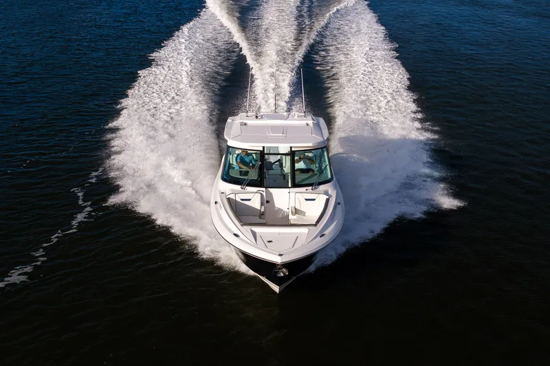 34 Tiara 2022 Yacht Photos Pics 2022 Tiara 34 LX boat cruising on open water, creating a dynamic wake.