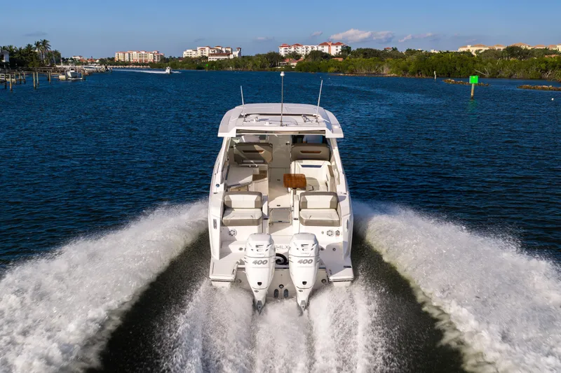 34 Tiara 2022 Yacht Photos Pics 2022 Tiara 34 LX boat cruising on a scenic waterway.