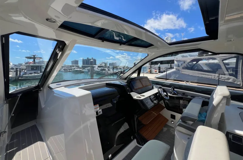 Donna Jane Yacht Photos Pics 2023 Sea Ray Sundancer 370 OB cockpit with modern helm, marina view.