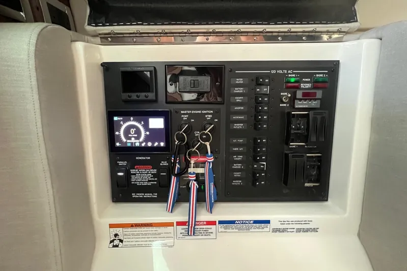 Donna Jane Yacht Photos Pics Control panel of a 2023 Sea Ray Sundancer 370 OB boat with keys hanging.