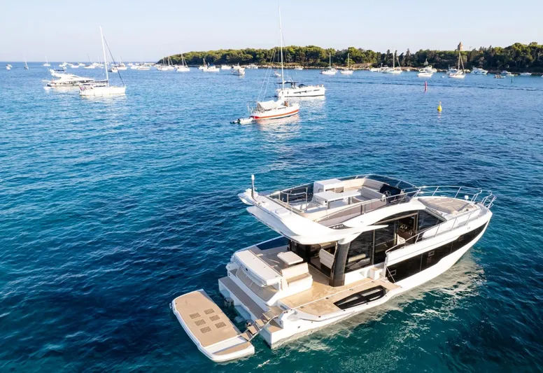  Yacht Photos Pics 2026 Galeon 440 Fly yacht on serene blue waters, surrounded by other boats.