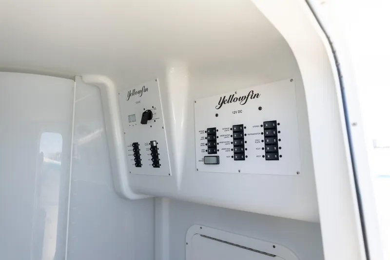 Fins Up Yacht Photos Pics Control panel of 2017 Yellowfin 42 Offshore boat, featuring labeled switches and dials.