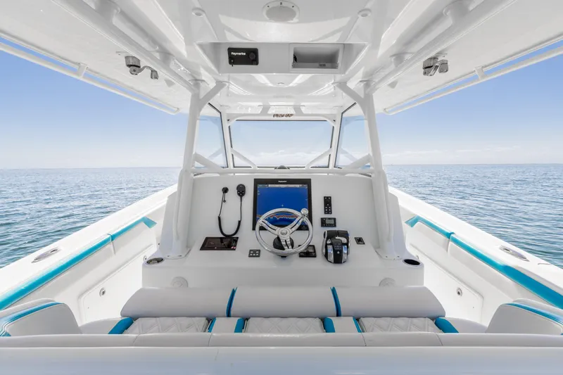 Fins Up Yacht Photos Pics 2017 Yellowfin 42 Offshore boat interior with steering console, ocean view.