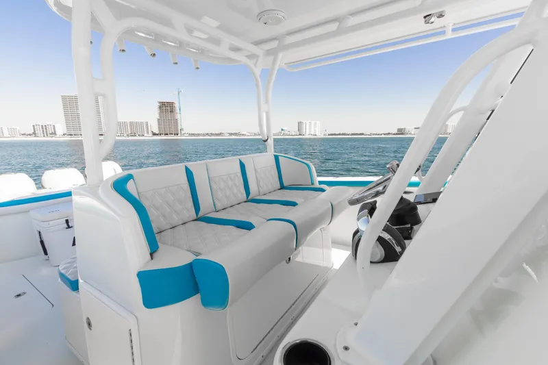 Fins Up Yacht Photos Pics 2017 Yellowfin 42 Offshore boat interior with blue and white seating, ocean view.