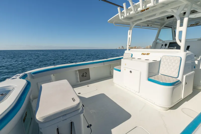 Fins Up Yacht Photos Pics 2017 Yellowfin 42 Offshore boat interior with ocean view, featuring seating and storage.
