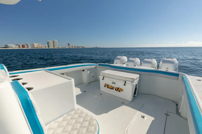 Fins Up Yacht Photos Pics 2017 Yellowfin 42 Offshore boat with ocean view and city skyline in background.