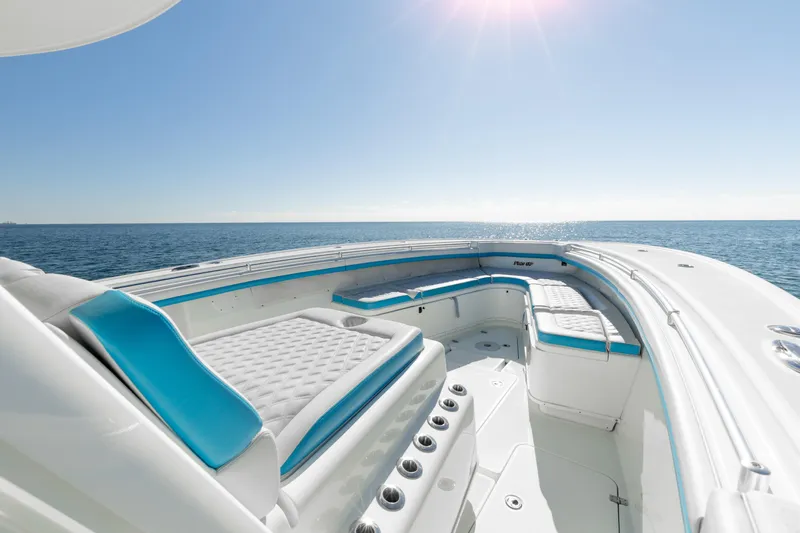 Fins Up Yacht Photos Pics 2017 Yellowfin 42 Offshore boat interior with blue and white seating, ocean view.