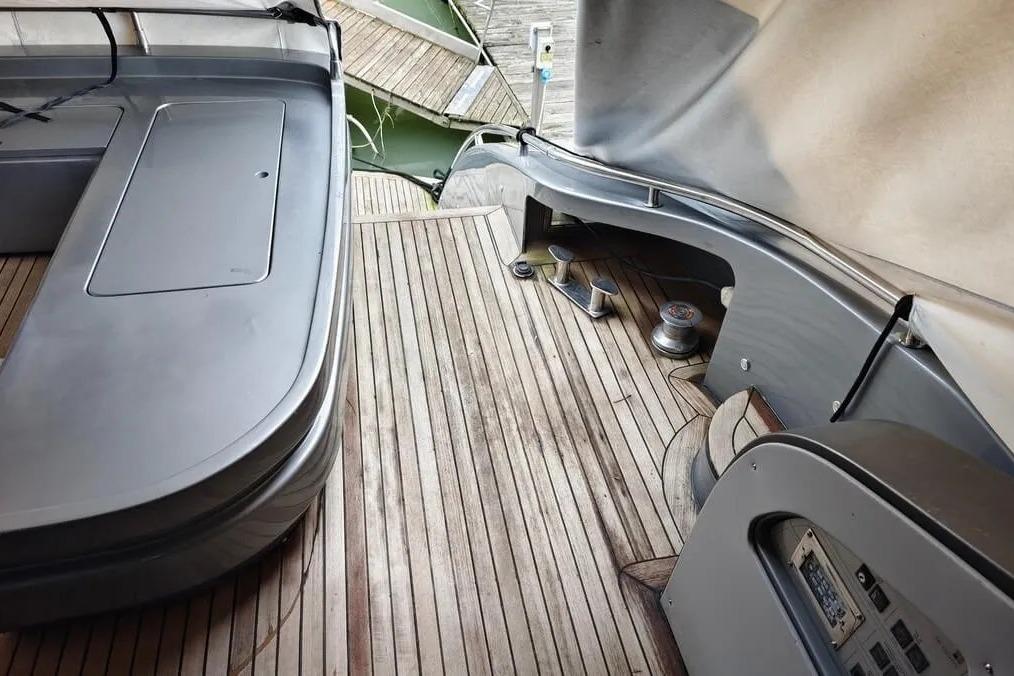 Deck of 2004 AB Yachts 68 with wooden flooring and sleek design elements.