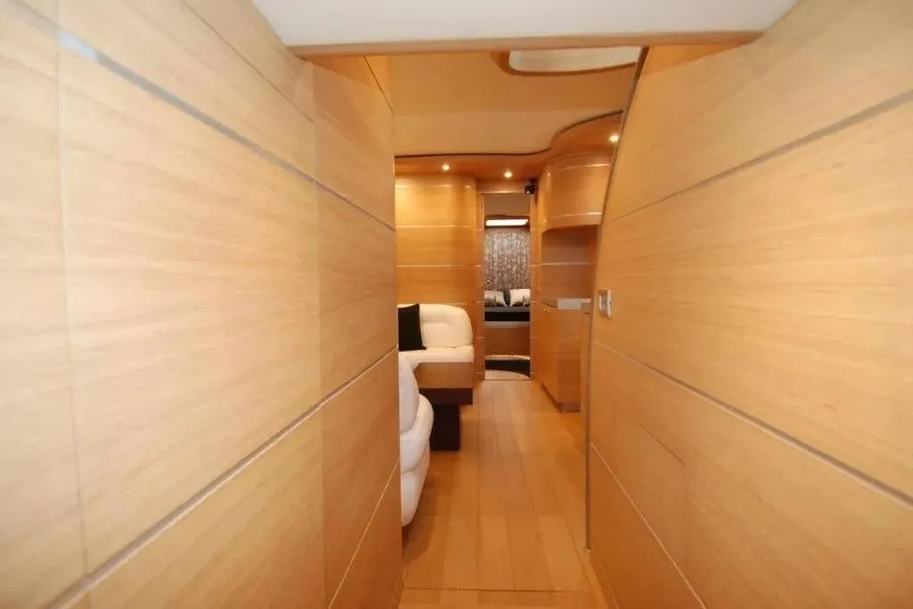 Luxurious interior of 2004 AB Yachts 68, featuring sleek wooden paneling and modern design.