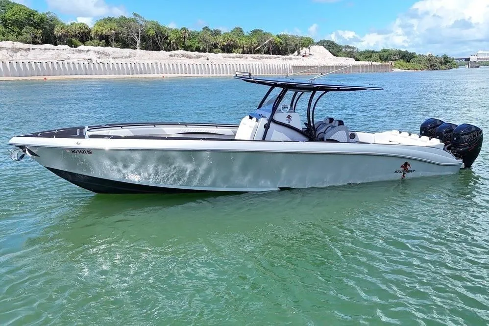 2016 Statement 380 Open boat on clear water, featuring sleek design and powerful engines.