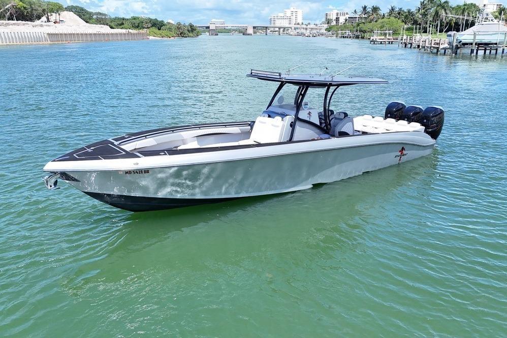 2016 Statement 380 Open boat on calm water, featuring sleek design and multiple engines.