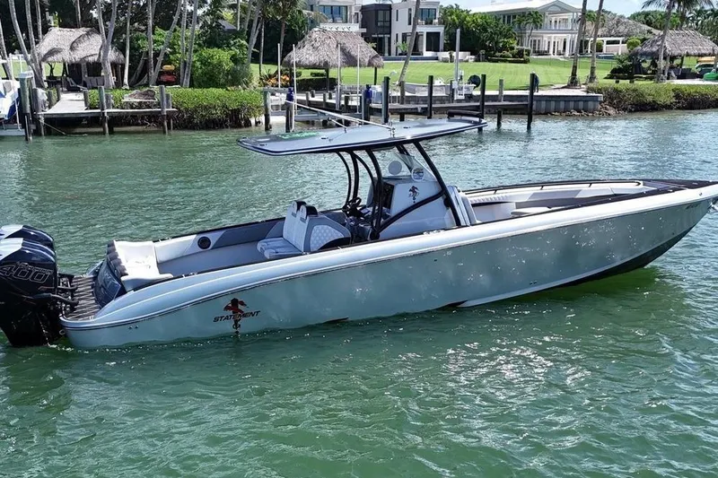  Yacht Photos Pics 2016 Statement 380 Open boat on water near a dockside residence.