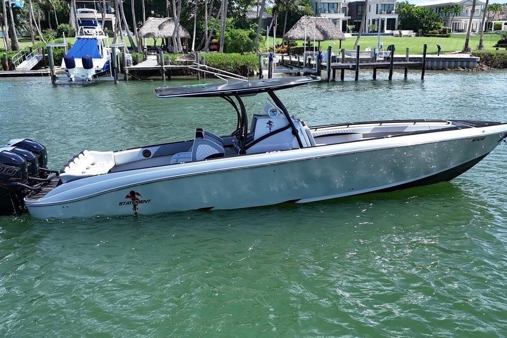 2016 Statement 380 Open boat on water near dockside homes.
