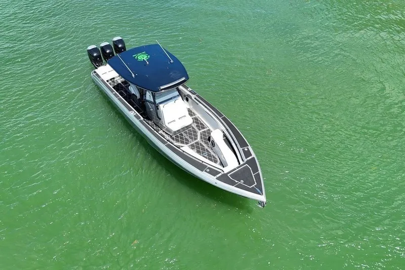  Yacht Photos Pics 2016 Statement 380 Open boat on vibrant green water, aerial view.