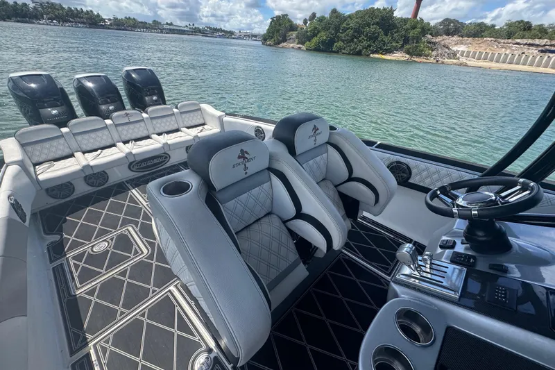  Yacht Photos Pics 2016 Statement 380 Open boat interior with luxurious seating and multiple engines on a scenic waterway.