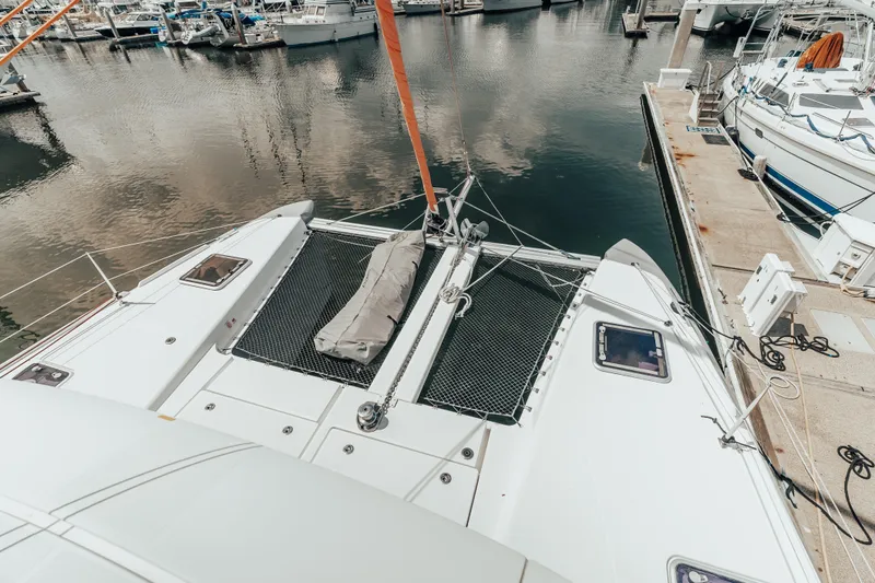 27 Reasons Yacht Photos Pics 2020 Excess 12 catamaran docked at marina, showcasing deck and netting.