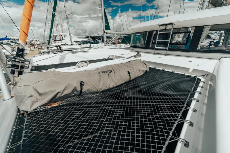 27 Reasons Yacht Photos Pics 2020 Excess 12 catamaran with netting and covered equipment on deck, docked at marina.