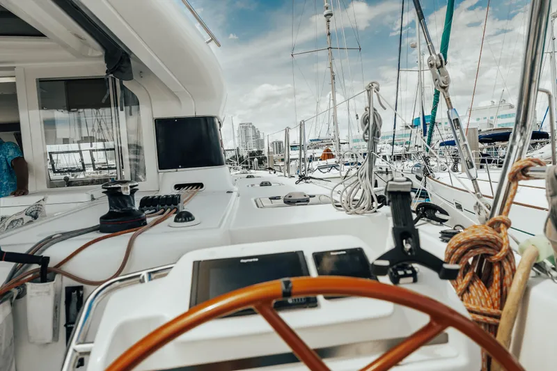 27 Reasons Yacht Photos Pics 2020 Excess 12 yacht deck with steering wheel and marina view.