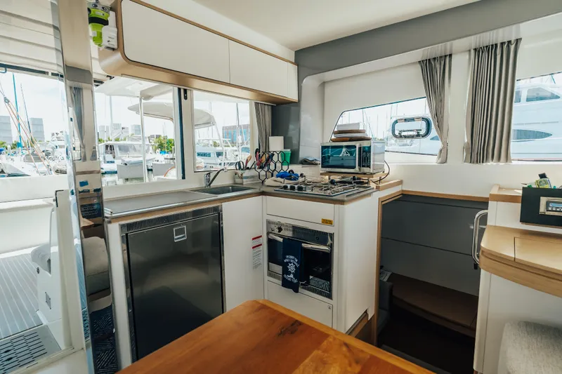 27 Reasons Yacht Photos Pics Modern kitchen interior of 2020 Excess 12 yacht with appliances and marina view.