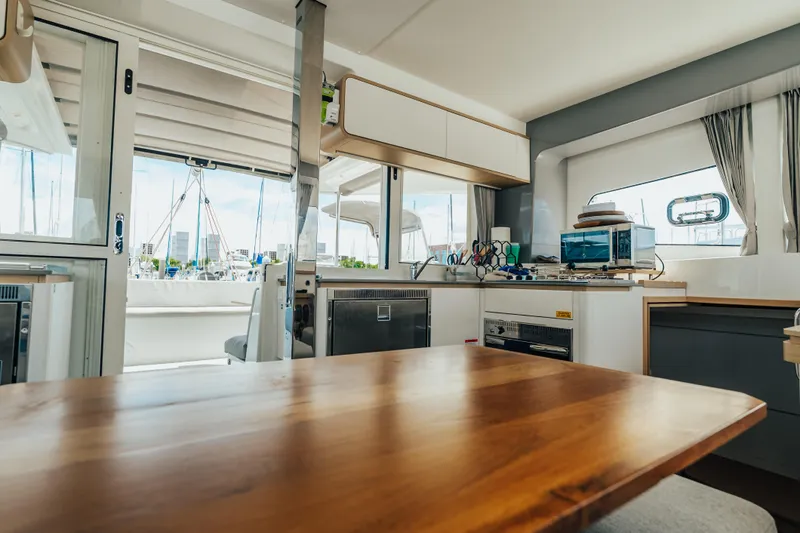 27 Reasons Yacht Photos Pics Interior of 2020 Excess 12 catamaran with modern kitchen and dining area.
